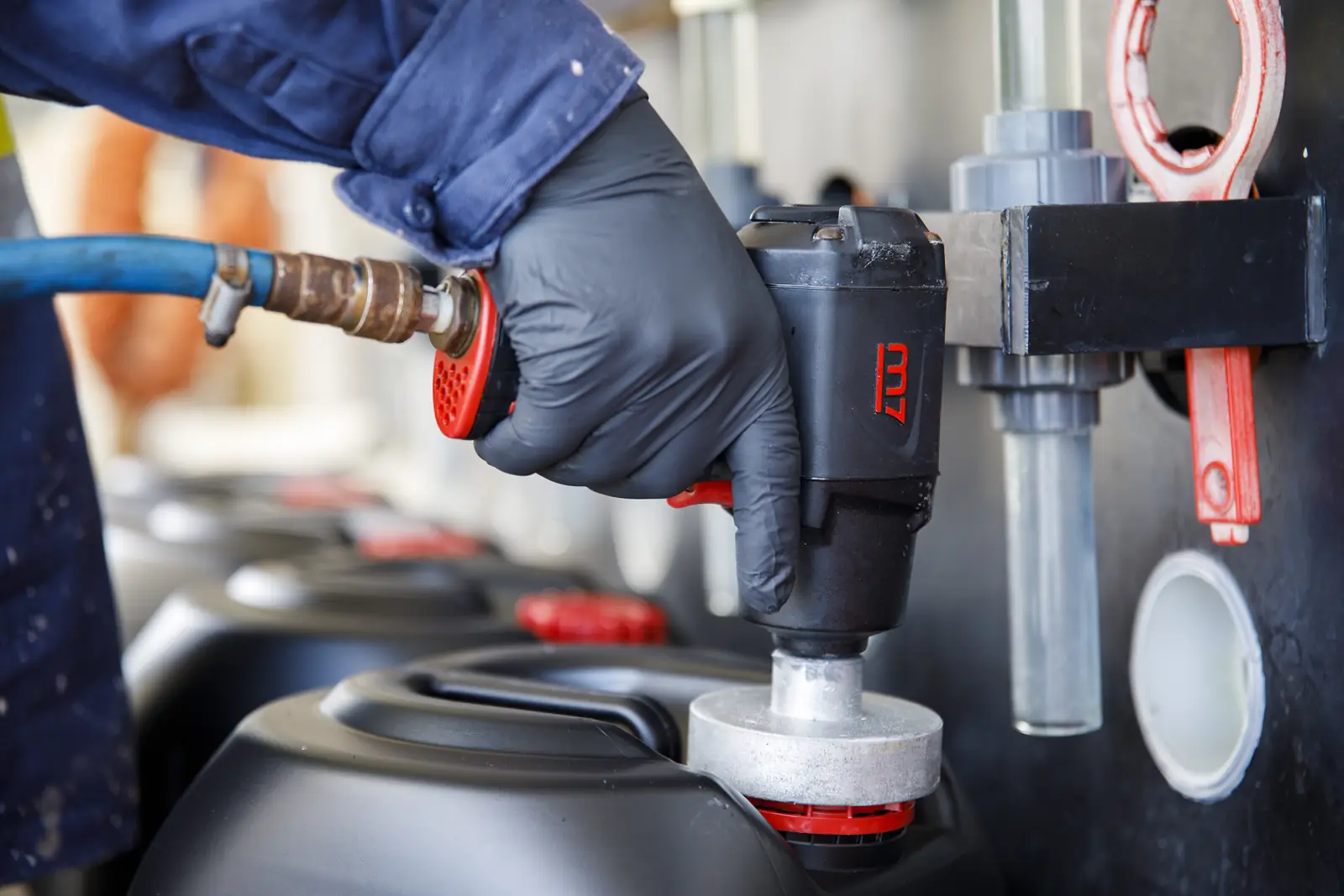 Gloved hands fitting a cap to a refilled AGent drum