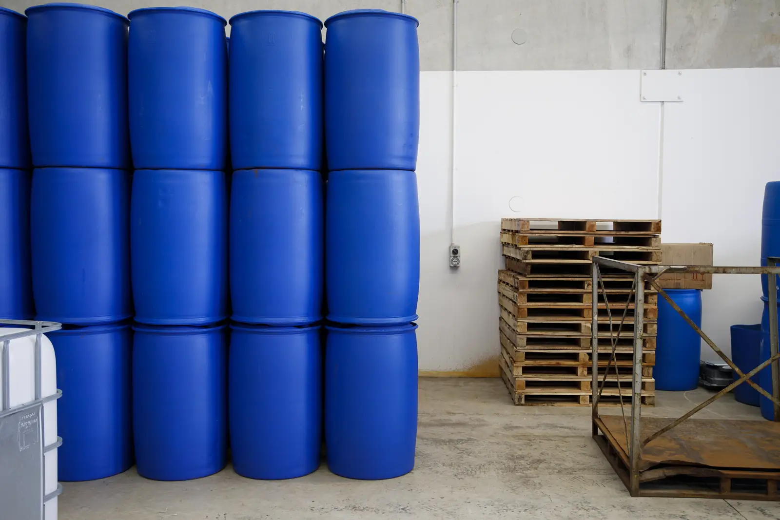 Stacked blue AGent chemical drums at the Bassendean plant